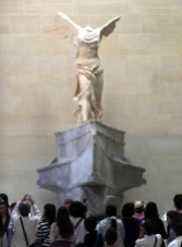 Crowds can be horrible. Here the famous sculpture, the so-called "Winged Victory," would be lost in the crowd if it were not elevated.